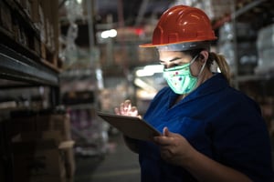 woman wearing a mask in a warehouse